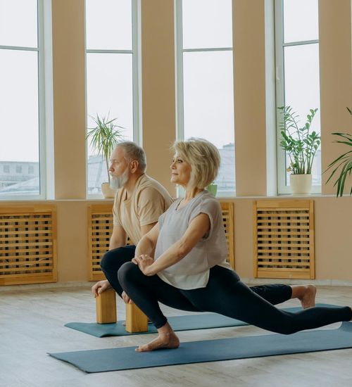 Woman performing a gentle yoga stretch in a calm environment.